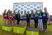 8 March 2025; The Institute of Education celebrate with the cup alongside second place finishers Sacred Heart Tullamore and third place finishers Abbey Community College in the Senior Girls 3,500m team event during the 123.ie All Ireland Schools Cross Country Championships at Galway Racecourse in Ballybrit, Galway. Photo by Tom Beary/Sportsfile