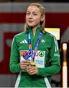 9 March 2025; Sarah Healy of Ireland with her gold medal while listening to her national anthem after winning the women's 3000m final on day four of the European Athletics Indoor Championships 2025 at the Omnisport Apeldoorn in Apeldoorn, Netherlands. Photo by Sam Barnes/Sportsfile