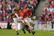 12 September 2004; Ben O'Connor, Cork, in action against James Ryall, Kilkenny. Guinness All-Ireland Senior Hurling Championship Final, Cork v Kilkenny, Croke Park, Dublin. Picture credit; Brendan Moran / SPORTSFILE *** Local Caption *** Any photograph taken by SPORTSFILE during, or in connection with, the 2004 Guinness All-Ireland Hurling Final which displays GAA logos or contains an image or part of an image of any GAA intellectual property, or, which contains images of a GAA player/players in their playing uniforms, may only be used for editorial and non-advertising purposes.  Use of photographs for advertising, as posters or for purchase separately is strictly prohibited unless prior written approval has been obtained from the Gaelic Athletic Association.