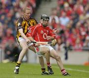 12 September 2004; Ben O'Connor, Cork, in action against James Ryall, Kilkenny. Guinness All-Ireland Senior Hurling Championship Final, Cork v Kilkenny, Croke Park, Dublin. Picture credit; Brendan Moran / SPORTSFILE *** Local Caption *** Any photograph taken by SPORTSFILE during, or in connection with, the 2004 Guinness All-Ireland Hurling Final which displays GAA logos or contains an image or part of an image of any GAA intellectual property, or, which contains images of a GAA player/players in their playing uniforms, may only be used for editorial and non-advertising purposes.  Use of photographs for advertising, as posters or for purchase separately is strictly prohibited unless prior written approval has been obtained from the Gaelic Athletic Association.