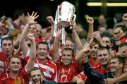 12 September 2004; Cork captain Ben O'Connor and team-mates celebrate with the Liam MacCarthy cup after victory over Kilkenny. Guinness All-Ireland Senior Hurling Championship Final, Cork v Kilkenny, Croke Park, Dublin. Picture credit; Brendan Moran / SPORTSFILE *** Local Caption *** Any photograph taken by SPORTSFILE during, or in connection with, the 2004 Guinness All-Ireland Hurling Final which displays GAA logos or contains an image or part of an image of any GAA intellectual property, or, which contains images of a GAA player/players in their playing uniforms, may only be used for editorial and non-advertising purposes.  Use of photographs for advertising, as posters or for purchase separately is strictly prohibited unless prior written approval has been obtained from the Gaelic Athletic Association.
