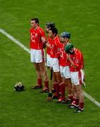 12 September 2004; Cork players stand for a minutes silence. Guinness All-Ireland Senior Hurling Championship Final, Cork v Kilkenny, Croke Park, Dublin. Picture credit; Pat Murphy / SPORTSFILE *** Local Caption *** Any photograph taken by SPORTSFILE during, or in connection with, the 2004 Guinness All-Ireland Hurling Final which displays GAA logos or contains an image or part of an image of any GAA intellectual property, or, which contains images of a GAA player/players in their playing uniforms, may only be used for editorial and non-advertising purposes.  Use of photographs for advertising, as posters or for purchase separately is strictly prohibited unless prior written approval has been obtained from the Gaelic Athletic Association.