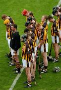 12 September 2004; The Kilkenny team stand for a minutes silence. Guinness All-Ireland Senior Hurling Championship Final, Cork v Kilkenny, Croke Park, Dublin. Picture credit; Pat Murphy / SPORTSFILE *** Local Caption *** Any photograph taken by SPORTSFILE during, or in connection with, the 2004 Guinness All-Ireland Hurling Final which displays GAA logos or contains an image or part of an image of any GAA intellectual property, or, which contains images of a GAA player/players in their playing uniforms, may only be used for editorial and non-advertising purposes.  Use of photographs for advertising, as posters or for purchase separately is strictly prohibited unless prior written approval has been obtained from the Gaelic Athletic Association.