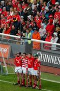 12 September 2004; Cork players and supporters stand for the National Anthem. Guinness All-Ireland Senior Hurling Championship Final, Cork v Kilkenny, Croke Park, Dublin. Picture credit; Pat Murphy / SPORTSFILE *** Local Caption *** Any photograph taken by SPORTSFILE during, or in connection with, the 2004 Guinness All-Ireland Hurling Final which displays GAA logos or contains an image or part of an image of any GAA intellectual property, or, which contains images of a GAA player/players in their playing uniforms, may only be used for editorial and non-advertising purposes.  Use of photographs for advertising, as posters or for purchase separately is strictly prohibited unless prior written approval has been obtained from the Gaelic Athletic Association.