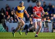 9 March 2025; Jack O'Connor of Cork handpasses as Rory Hayes of Clare closes in during the Allianz Hurling League Division 1A match between Clare and Cork at Zimmer Biomet Páirc Chíosóg in Ennis, Clare. Photo by Piaras Ó Mídheach/Sportsfile