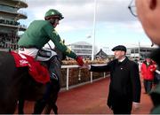 12 March 2025; Jockey Keith Donoghue, aboard Stumptown, is congratulated by trainer Gavin Cromwell, right, after winning The Glenfarclas Cross Country Steeple Chase on day two of the Cheltenham Racing Festival at Prestbury Park in Cheltenham, England. Photo by Harry Murphy/Sportsfile