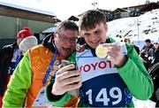 12 March 2025; Caolan McConville of Team Ireland, a member of Skiability Northern Ireland, Aghaghallon, Antrim,  with his Gold Medal, a first ever Gold for a Special Olympics Ireland athlete at Advanced level, is contratulated by his  dad Pearar, on day four of the Turin 2025 Special Olympics World Winter Games in Sestriere, Italy. Photo by Ray McManus/Sportsfile