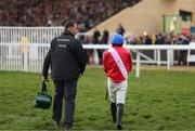 12 March 2025; Jockey Darragh O'Keeffe walks back after being unseated at the last by Quilixios during The BetMGM Queen Mother Champion Steeple Chase on day two of the Cheltenham Racing Festival at Prestbury Park in Cheltenham, England. Photo by Harry Murphy/Sportsfile