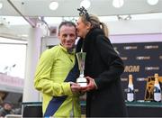 12 March 2025; Jockey Sean Flanagan celebrates with his wife Lauren after winning The BetMGM Queen Mother Champion Steeple Chase with Marine Nationale on day two of the Cheltenham Racing Festival at Prestbury Park in Cheltenham, England. Photo by David Fitzgerald/Sportsfile