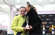 12 March 2025; Jockey Sean Flanagan celebrates with his wife Lauren after winning The BetMGM Queen Mother Champion Steeple Chase with Marine Nationale on day two of the Cheltenham Racing Festival at Prestbury Park in Cheltenham, England. Photo by David Fitzgerald/Sportsfile