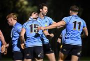 13 March 2025; Tim Corkery of UCD, 15, is congratulated by teammates including Ross Deegan, centre, and Alex O'Grady, right, after scoring his sides first try during the annual men’s Rugby Colours match between Dublin University and UCD at UCD Bowl in Dublin. Photo by Sam Barnes/Sportsfile