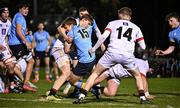 13 March 2025; Tim Corkery of UCD on his way to scoring his side's first try despite the efforts of James O'Sullivan, left, and Hugo Lynch of Dublin University during the annual men’s Rugby Colours match between Dublin University and UCD at UCD Bowl in Dublin. Photo by Sam Barnes/Sportsfile