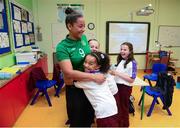 8 October 2013; Irish International footballer Rianna Jarrett receives a hug from 10 year old Kayla Smith, a pupil at St. John of God NS in Wexford, at the launch of the Aviva Soccer Sisters Halloween Camps. The camps will take place over the Halloween Break and are open to all girls between the ages of 7 and 12 years old. For more information log on to www.AVIVA.ie/SoccerSisters. St John of God National School, The Faythe, Wexford. Photo by Sportsfile