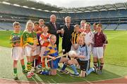 11 October 2013; Former GAA President Sean Kelly MEP, right, presents Uachtarán Chumann Lúthchleas Gael Liam Ó Néill with the European Citizen's medal, in the company of children from the Holy Trinity School, Donaghmede, from left, Robert O'Connor, Amy Redmond, Tmoni Nolan, Aaron O'Mahony, Dylan Fowler, Gemma Keenan, Megan Kennedy, Gavin Donegan, Sarah Keenan, Hollyjo Clarke, Jasmine Kamtoh and John O'Reilly, after the Gaelic Athletic Association was announced as winner of the European Citizen's Prize 2013. Croke Park, Dublin. Picture credit: Matt Browne / SPORTSFILE