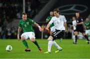 11 October 2013; Glenn Whelan, Republic of Ireland, in action against Marcell Jansen, Germany. 2014 FIFA World Cup Qualifier, Group C, Germany v Republic of Ireland, Rhine Energie Stadion, Cologne, Germany.  Picture credit: David Maher / SPORTSFILE