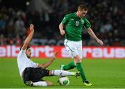 11 October 2013; James McCarthy, Republic of Ireland, in action against Sami Khedira, Germany. 2014 FIFA World Cup Qualifier, Group C, Germany v Republic of Ireland, Rhine Energie Stadion, Cologne, Germany.  Picture credit: David Maher / SPORTSFILE