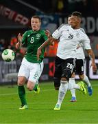 11 October 2013; James McCarthy, Republic of Ireland, in action against Jérôme Boateng, Germany. 2014 FIFA World Cup Qualifier, Group C, Germany v Republic of Ireland, Rhine Energie Stadion, Cologne, Germany. Picture credit: David Maher / SPORTSFILE