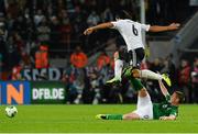 11 October 2013; James McCarthy, Republic of Ireland, tackles Sami Khedira, Germany. 2014 FIFA World Cup Qualifier, Group C, Germany v Republic of Ireland, Rhine Energie Stadion, Cologne, Germany.  Picture credit: David Maher / SPORTSFILE