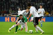 11 October 2013; James McCarthy, Republic of Ireland, in action against Sami Khedira, right, and Marcell Jansen, Germany. 2014 FIFA World Cup Qualifier, Group C, Germany v Republic of Ireland, Rhine Energie Stadion, Cologne, Germany.  Picture credit: David Maher / SPORTSFILE
