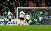 11 October 2013; Germany's André Schürrle, 9, shoots to score his side's second goal despite the attempts of the Republic of Ireland's Stephen Kelly. 2014 FIFA World Cup Qualifier, Group C, Germany v Republic of Ireland, Rhine Energie Stadion, Cologne, Germany. Picture credit: David Maher / SPORTSFILE