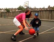 1 October 1998; Eimear Brophy of Killester shows Sam McCarthy, aged 6, some dribbling skills at Loreto School in Dublin ahead of the ESB Basketball Superleague which starts on the Weekend of the 2nd October 1998.Photo by David Maher/Sportsfile.