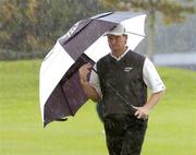 1 October 2004; Ernie Els shelters from a rain storm on the 8th fairway during round two of the American Express World Golf Championship 2004, Mount Juliet Golf Club, Thomastown, Co. Kilkenny. Picture credit; Matt Browne / SPORTSFILE