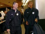 7 October 2004; Roy Keane, Republic of Ireland, and team-mate Clinton Morrison on their arrival at Charles De Gaulle Airport prior to their FIFA World Cup 2006 Qualifier game against France. Paris, France. Picture credit; David Maher / SPORTSFILE