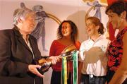 13 October 2004; Eileen Duffy O'Mahony shows the Eileen Dubhthaigh Ui Mhathuna cup to Annette Mc Geeney, Ireland vice captain, left, Ann Marie O'Dwyer, centre, An Bhreatain captain and Chris Hanley, right, USA captain, at the launch of the 2004 Coca Cola International camogie competition between Ireland, An Bhreatain, and USA. Citywest Hotel, Dublin. Picture credit; Pat Murphy / SPORTSFILE