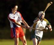 15 October 2004; Rosie O'Reilly, USA, in action against Orla Carey, Ireland. 2004 Coca Cola International Camogie Competition, Ireland v USA, St. Brigids GAA Club, Dublin. Picture credit; Matt Browne / SPORTSFILE