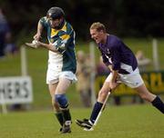 16 October 2004; Mervyn Connaughton, Ireland, in action against Lachlann Campbell, Scotland. Senior Mens Hurling Shinty International, Ireland v Scotland, Rathoath GAA Club, Phairc Sean Eiffe, Co. Meath. Picture credit; Damien Eagers / SPORTSFILE