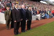 24 October 2004; Andrew Demetriou, Chief Executive of the AFL, An Taoiseach Bertie Ahern TD and Sean Kelly, President of the GAA, stand for the An Taoiseach's salute by the Garda band. Coca Cola International Rules Series 2004, Second Test, Ireland v Australia, Croke Park, Dublin. Picture credit; Brendan Moran / SPORTSFILE *** Local Caption *** Any photograph taken by SPORTSFILE during, or in connection with, the 2004 Coca Cola International Rules Series which displays GAA logos or contains an image or part of an image of any GAA intellectual property, or, which contains images of a GAA player/players in their playing uniforms, may only be used for editorial and non-advertising purposes.  Use of photographs for advertising, as posters or for purchase separately is strictly prohibited unless prior written approval has been obtained from the Gaelic Athletic Association.