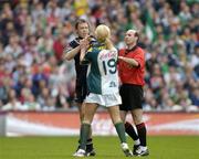 24 October 2004; Referee Michael Collins attempts to separate Ireland's Ciaran McDonald and Australia's Max Hudghton. Coca Cola International Rules Series 2004, Second Test, Ireland v Australia, Croke Park, Dublin. Picture credit; Brendan Moran / SPORTSFILE *** Local Caption *** Any photograph taken by SPORTSFILE during, or in connection with, the 2004 Coca Cola International Rules Series which displays GAA logos or contains an image or part of an image of any GAA intellectual property, or, which contains images of a GAA player/players in their playing uniforms, may only be used for editorial and non-advertising purposes.  Use of photographs for advertising, as posters or for purchase separately is strictly prohibited unless prior written approval has been obtained from the Gaelic Athletic Association.