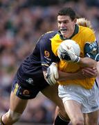 24 October 2004; Stephen Cluxton, Ireland, in action against Adam McPhee, Australia. Coca Cola International Rules Series 2004, Second Test, Ireland v Australia, Croke Park, Dublin. Picture credit; Brendan Moran / SPORTSFILE *** Local Caption *** Any photograph taken by SPORTSFILE during, or in connection with, the 2004 Coca Cola International Rules Series which displays GAA logos or contains an image or part of an image of any GAA intellectual property, or, which contains images of a GAA player/players in their playing uniforms, may only be used for editorial and non-advertising purposes.  Use of photographs for advertising, as posters or for purchase separately is strictly prohibited unless prior written approval has been obtained from the Gaelic Athletic Association.