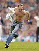 24 October 2004; A half naked man runs around the pitch at half-time. Coca Cola International Rules Series 2004, Second Test, Ireland v Australia, Croke Park, Dublin. Picture credit; Brendan Moran / SPORTSFILE *** Local Caption *** Any photograph taken by SPORTSFILE during, or in connection with, the 2004 Coca Cola International Rules Series which displays GAA logos or contains an image or part of an image of any GAA intellectual property, or, which contains images of a GAA player/players in their playing uniforms, may only be used for editorial and non-advertising purposes.  Use of photographs for advertising, as posters or for purchase separately is strictly prohibited unless prior written approval has been obtained from the Gaelic Athletic Association.