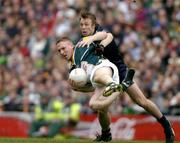 24 October 2004; David Heaney, Ireland, in action against Max Hudghton, Australia. Coca Cola International Rules Series 2004, Second Test, Ireland v Australia, Croke Park, Dublin. Picture credit; Brendan Moran / SPORTSFILE *** Local Caption *** Any photograph taken by SPORTSFILE during, or in connection with, the 2004 Coca Cola International Rules Series which displays GAA logos or contains an image or part of an image of any GAA intellectual property, or, which contains images of a GAA player/players in their playing uniforms, may only be used for editorial and non-advertising purposes.  Use of photographs for advertising, as posters or for purchase separately is strictly prohibited unless prior written approval has been obtained from the Gaelic Athletic Association.