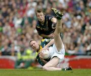 24 October 2004; David Heaney, Ireland, in action against Max Hudghton, Australia. Coca Cola International Rules Series 2004, Second Test, Ireland v Australia, Croke Park, Dublin. Picture credit; Brendan Moran / SPORTSFILE *** Local Caption *** Any photograph taken by SPORTSFILE during, or in connection with, the 2004 Coca Cola International Rules Series which displays GAA logos or contains an image or part of an image of any GAA intellectual property, or, which contains images of a GAA player/players in their playing uniforms, may only be used for editorial and non-advertising purposes.  Use of photographs for advertising, as posters or for purchase separately is strictly prohibited unless prior written approval has been obtained from the Gaelic Athletic Association.