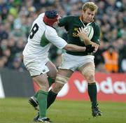 13 November 2004; AJ Venter, South Africa, is tackled by Anthony Foley, Ireland. Rugby International, Ireland v South Africa, Lansdowne Road, Dublin. Picture credit; Brendan Moran / SPORTSFILE