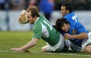 6 February 2005; Denis Hickie, Ireland, on his way to scoring his sides third try despite the tackles of Kaine Paul Robertson and Ludovico Orquera, Italy. RBS Six Nations Championship 2005, Italy v Ireland, Stadio Flamino, Rome, Italy. Picture credit; Brendan Moran / SPORTSFILE