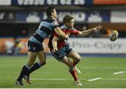 23 November 2013; Ivan Dineen, Munster, clears under pressure from Richard Smith, Cardiff Blues. Celtic League 2013/14, Round 8, Cardiff Blues v Munster, Arms Park, Cardiff, Wales. Picture credit: Ian Cook / SPORTSFILE