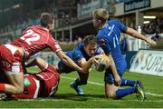 30 November 2013; Eoin Reddan, Leinster, goes over to score a try despite the tackle of Josh Lewis, Scarlets. Celtic League 2013/14, Round 9, Leinster v Scarlets, RDS, Ballsbridge, Dublin. Picture credit: Stephen McCarthy / SPORTSFILE
