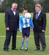 8 March 2005; Ian Tolan, aged 9, from Skerries, Co. Dublin, shows off his soccer skills to Cormac Farrell, left, Commercial Manager, O'Neills, and Liam Farrell, General Secretary of the North Dublin Schoolboys/girls League,  at the announcement that the North Dublin Schoolboys/girls League has agreed a new 5 year contract with O'Neills Irish International Sports Co Ltd. O'Neills also launched their new FIFA approved match football.. Amateur League Complex, Dublin. Picture credit; David Maher / SPORTSFILE