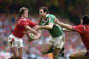 19 March 2005; Geordan Murphy, Ireland, is tackled by Shane Williams, left, and Ryan Jones, Wales. RBS Six Nations Championship 2005, Wales v Ireland, Millennium Stadium, Cardiff, Wales. Picture credit; Brendan Moran / SPORTSFILE