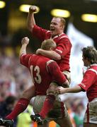 19 March 2005; Martyn Williams, Tom Shanklin (13) and Shane Williams, Wales, celebrate after winning the Grand Slam. RBS Six Nations Championship 2005, Wales v Ireland, Millennium Stadium, Cardiff, Wales. Picture credit; Brendan Moran / SPORTSFILE