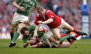 19 March 2005; Geordan Murphy, Ireland, loses possession while being tackled by Martyn Williams and Gethin Jenkins, right, Wales. RBS Six Nations Championship 2005, Wales v Ireland, Millennium Stadium, Cardiff, Wales. Picture credit; Brendan Moran / SPORTSFILE