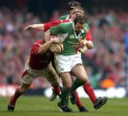 19 March 2005; Geordan Murphy, Ireland, loses possession while being tackled by Martyn Williams, left, and Gethin Jenkins, Wales. RBS Six Nations Championship 2005, Wales v Ireland, Millennium Stadium, Cardiff, Wales. Picture credit; Brendan Moran / SPORTSFILE