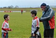 5 January 2014; Cork manager Brian Cuthbert signs his autograph on the jersey of 11-year-old AJ Whelan, along with his brother Luke Whelan, aged 9, from Donoughmore, Co. Cork, after the game. McGrath Cup, Quarter-Final, Cork v Limerick Institute of Technology, Mallow GAA Grounds, Mallow, Co. Cork. Picture credit: Diarmuid Greene / SPORTSFILE