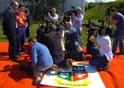 11 April 2005; Photographers and TV cameramen stand on the British and Irish Lions logo as they photograph captain Brian O'Driscoll with head coach Sir Clive Woodward at a press conference to announce the British & Irish Lions squad and captain. Hilton Hotel, Heathrow, London, England. Picture credit; Brendan Moran / SPORTSFILE