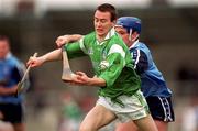 4 April 1999; Donie Ryan of Limerick in action against John Finnegan of Dublin during the Church and General National Hurling League Division 1A match between Dublin and Limerick at Parnell Park in Dublin. Photo by Ray McManus/Sportsfile
