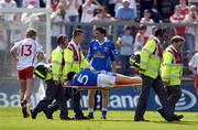 19 June 2005; Paul Brady, Cavan, stretchered off just after being red carded by referee Gerry Kinneavy. Bank of Ireland Ulster Senior Football Championship Semi-Final, Tyrone v Cavan, St. Tighernach's Park, Clones, Co. Monaghan. Picture credit; Pat Murphy / SPORTSFILE