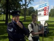 2 July 2005; Sergeant Kieran McCarthy watches Thomas Bjorn, Denmark, putt on the 4th green during the third round of the Smurfit European Open. K Club, Straffan, Co. Kildare. Picture credit; Damien Eagers / SPORTSFILE